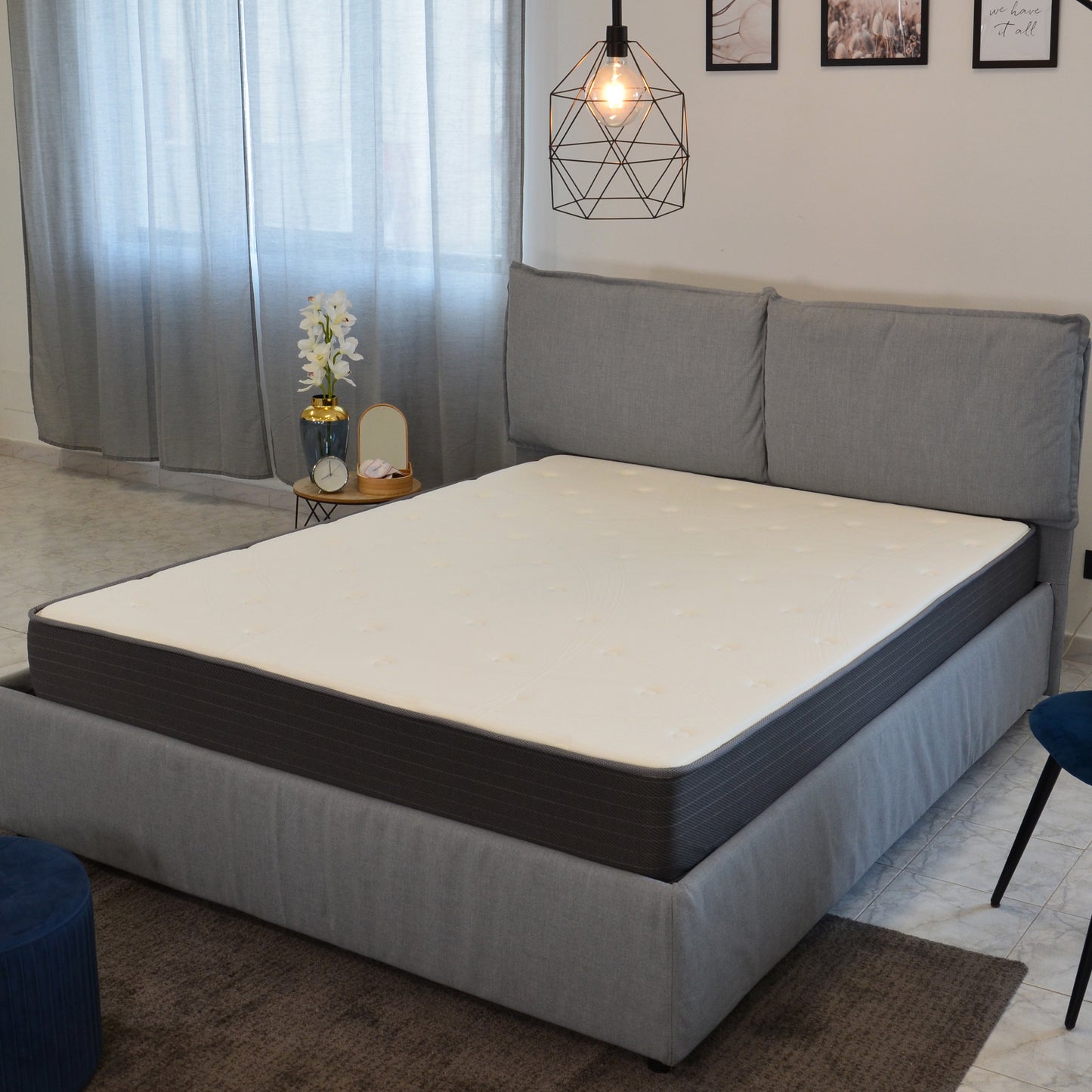 Luxury queen size mattress with a white quilted top and dark grey striped sides for comfortable sleep