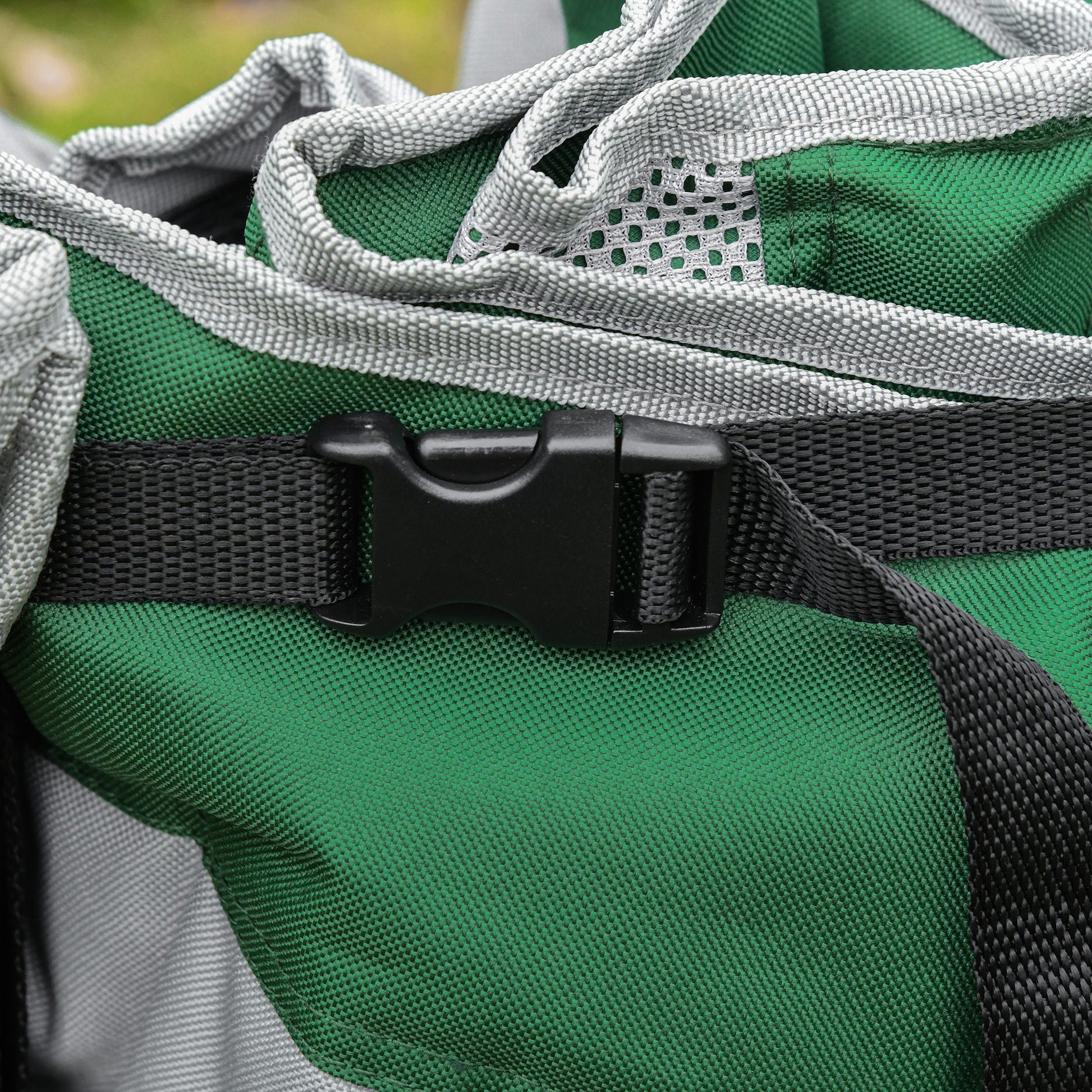 Closeup of a green and gray camping chair with a black buckle strap
