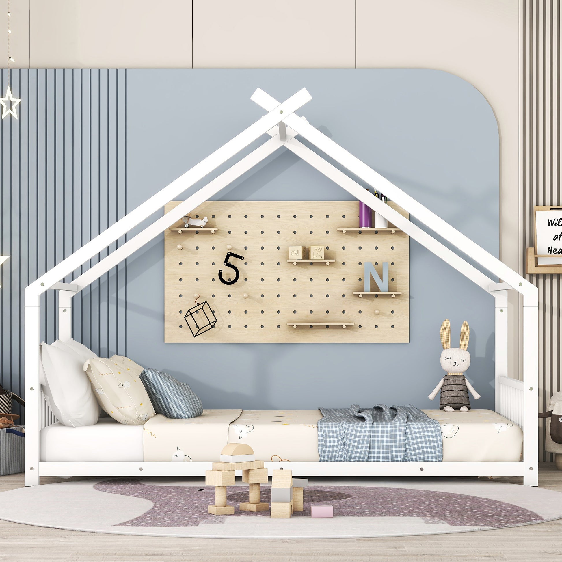 White wooden house bed frame with playful bedding and stuffed bunny toy