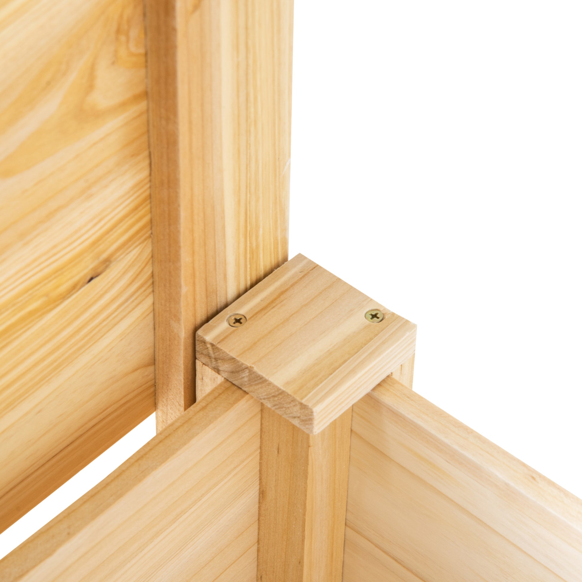Closeup of natural pine wood corner joint with visible screws for raised garden bed assembly