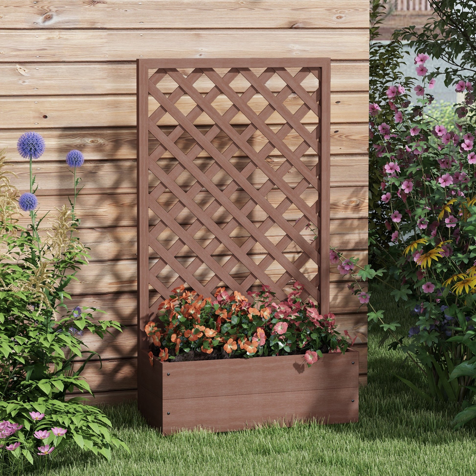 Brown lattice planter with colorful flowers and green foliage against a wooden fence