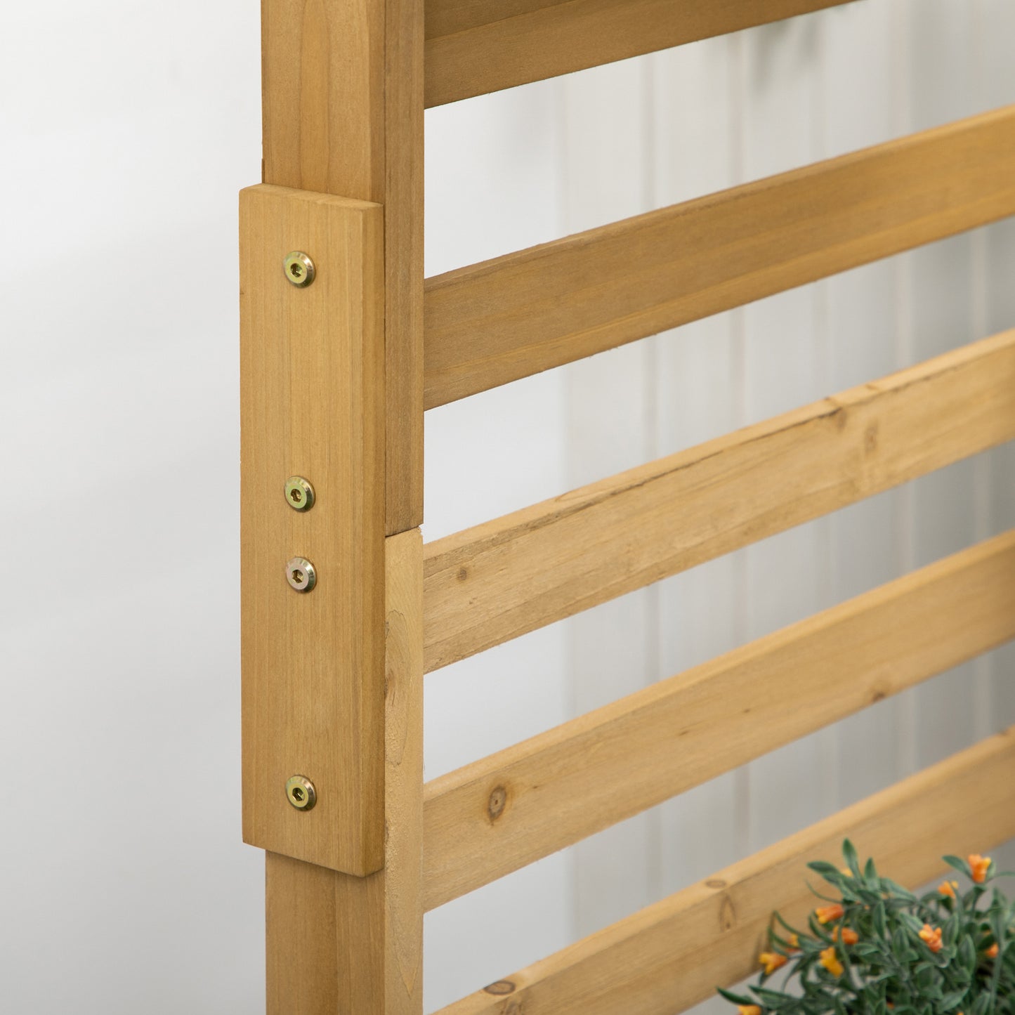 Closeup of a natural wood garden trellis with horizontal slats and metal fasteners for climbing plants