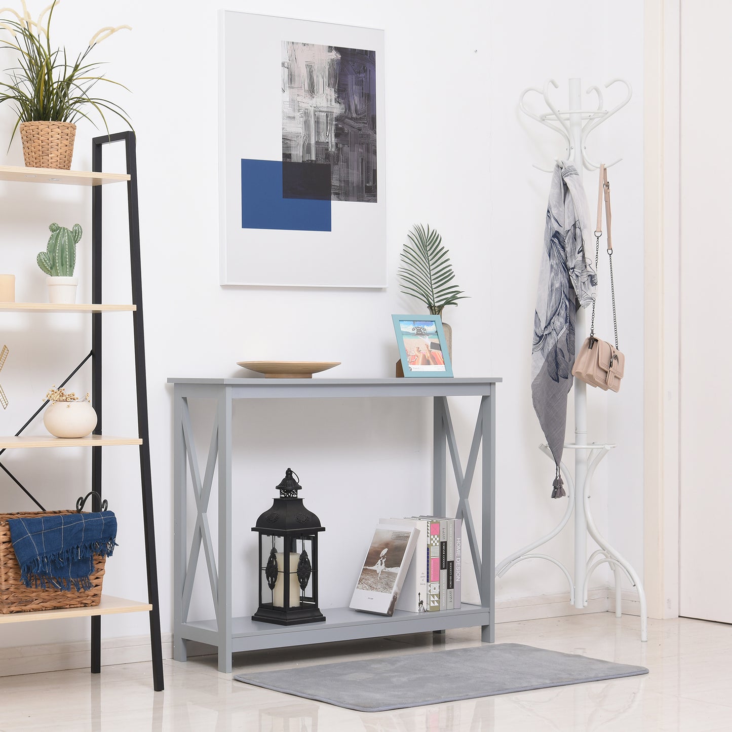 Gray Xframe console table with decorative books and black lantern for entryway decor