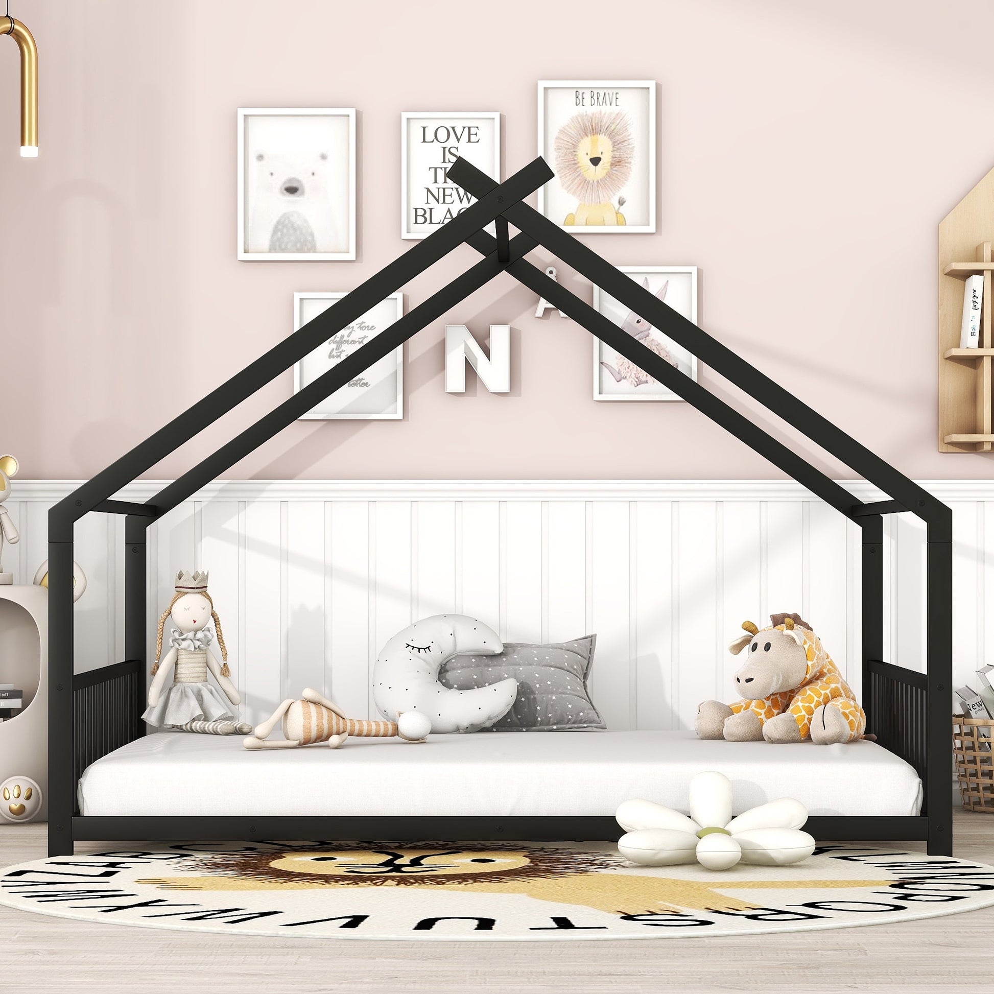 Black metal house frame bed with white mattress and scattered plush toys