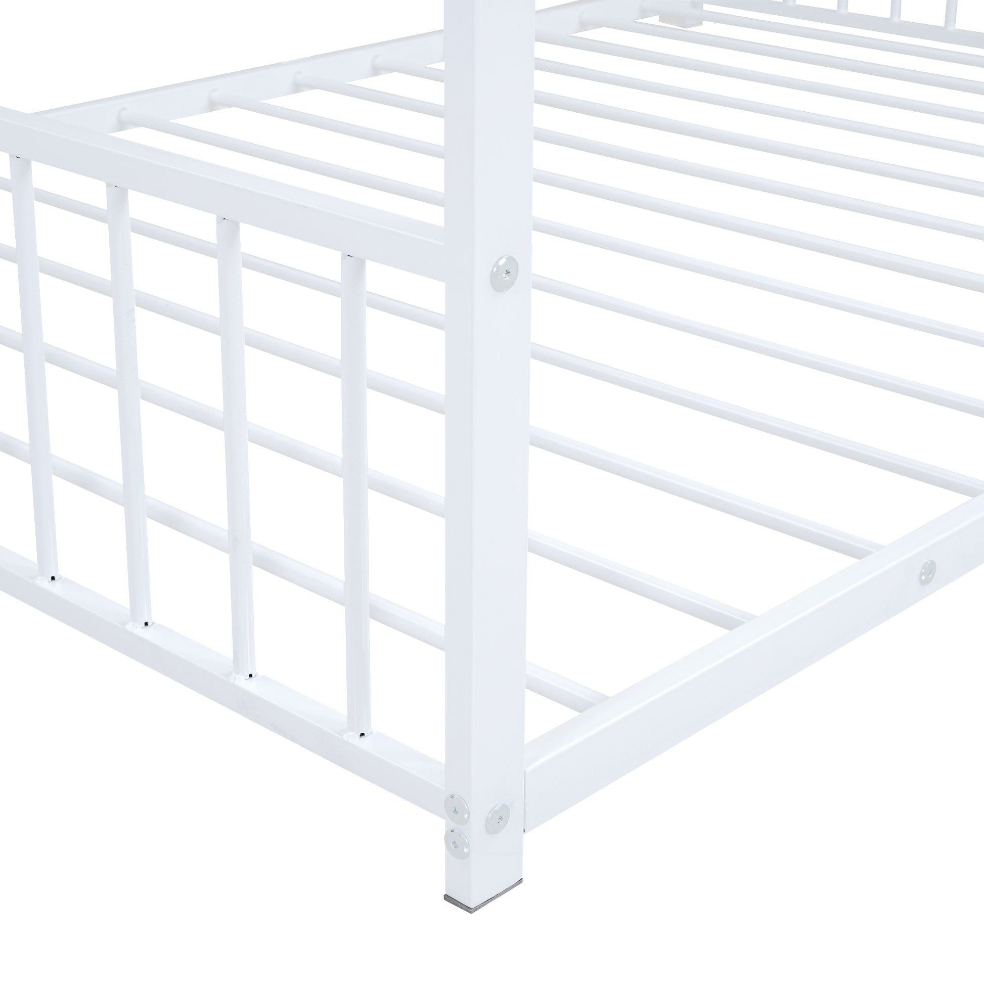 Closeup of white metal bed frame with slatted base and support posts