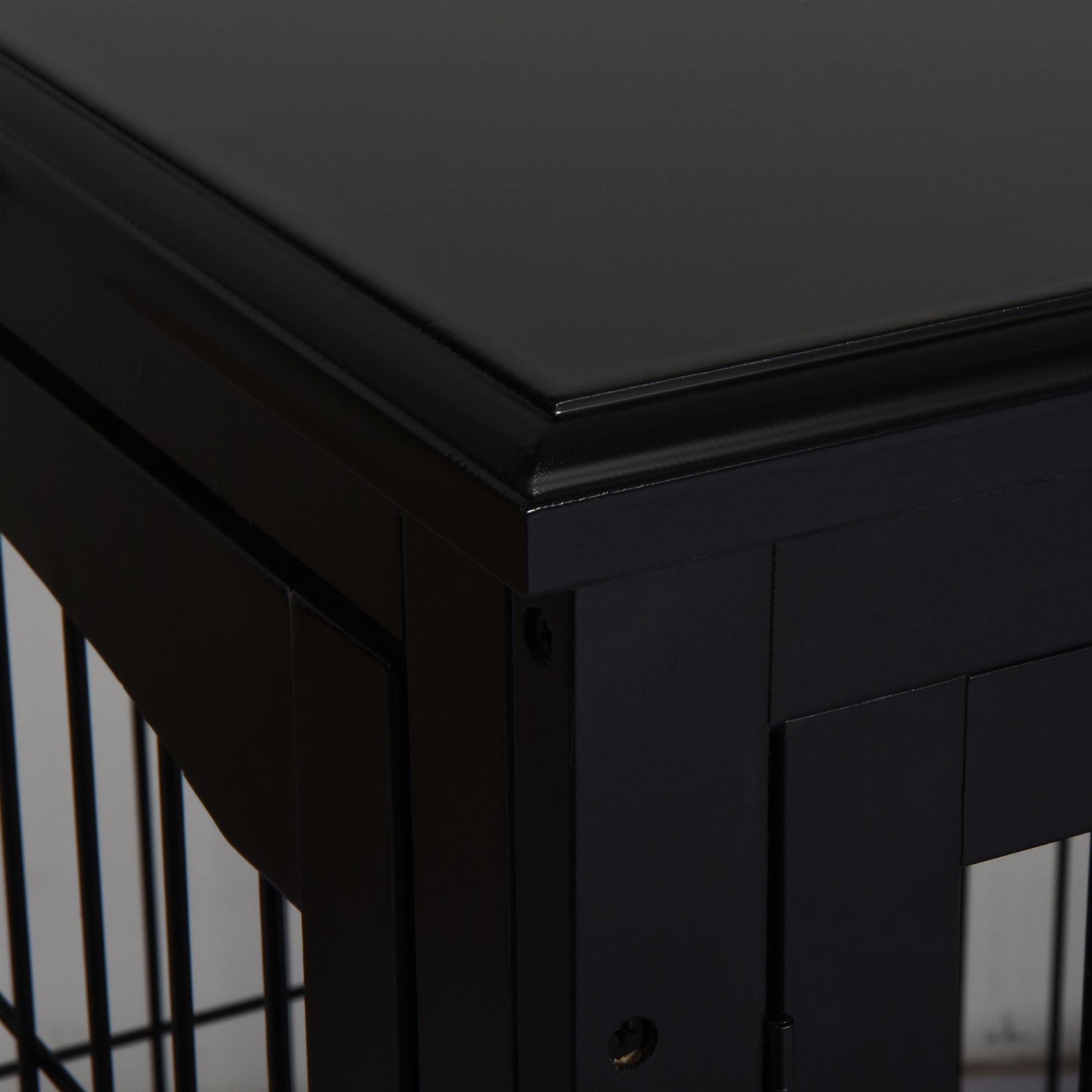 Black wooden dog crate detail with framed panels and rounded top edge