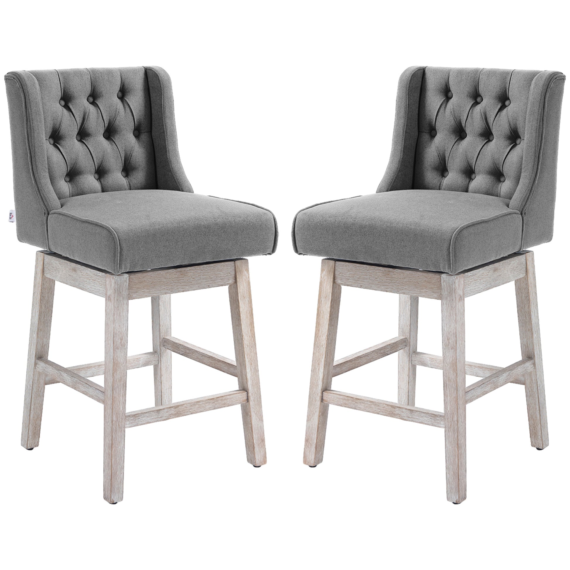 Two grey fabric tufted swivel bar stools with distressed wooden legs perfect for a modern kitchen island