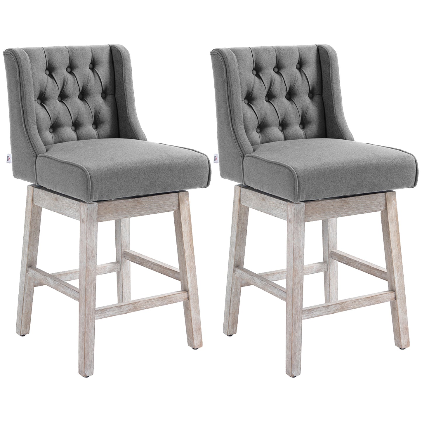 Two gray upholstered bar stools with tufted backs and weathered wood bases