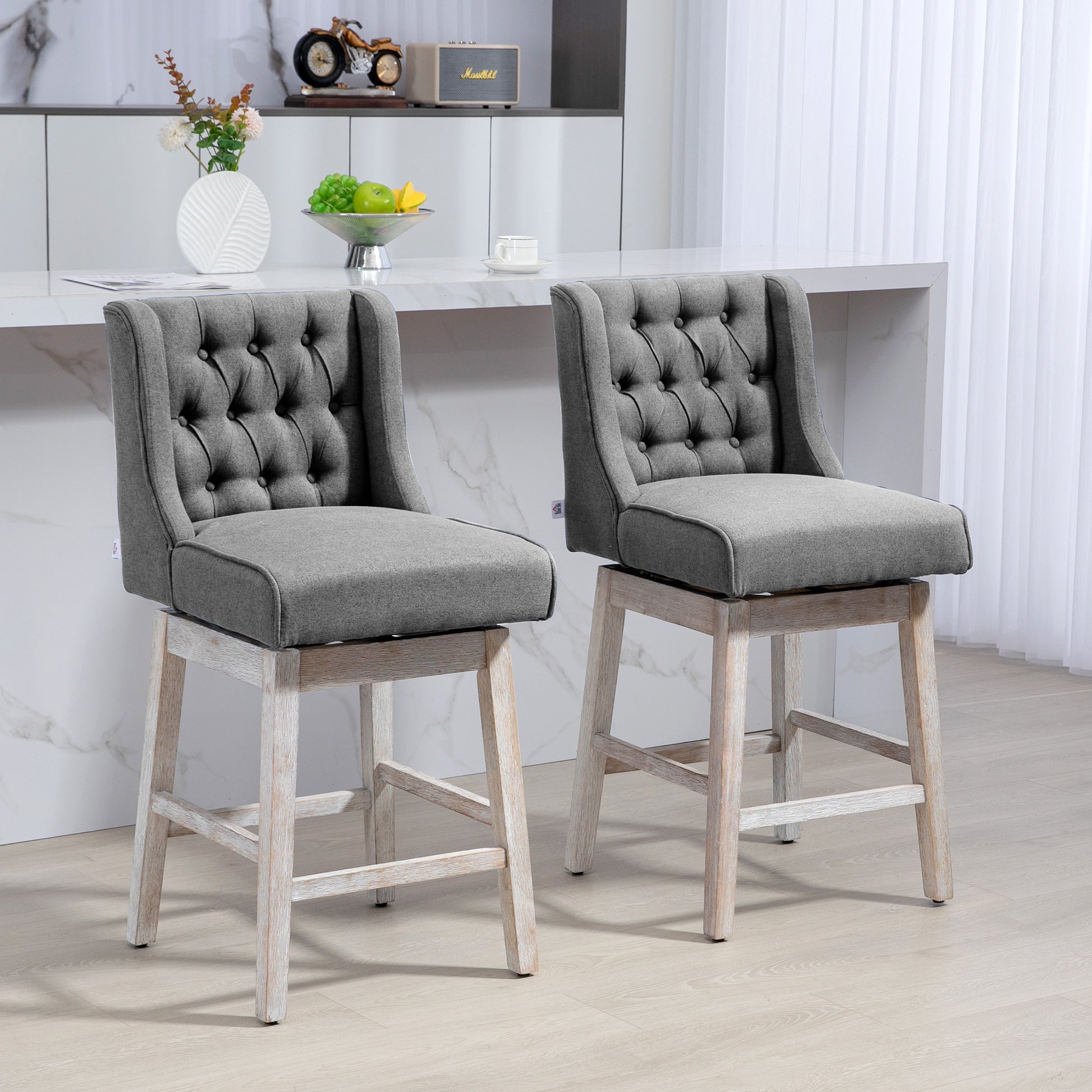 Tufted grey fabric swivel bar stool with weathered wood base and button detailing