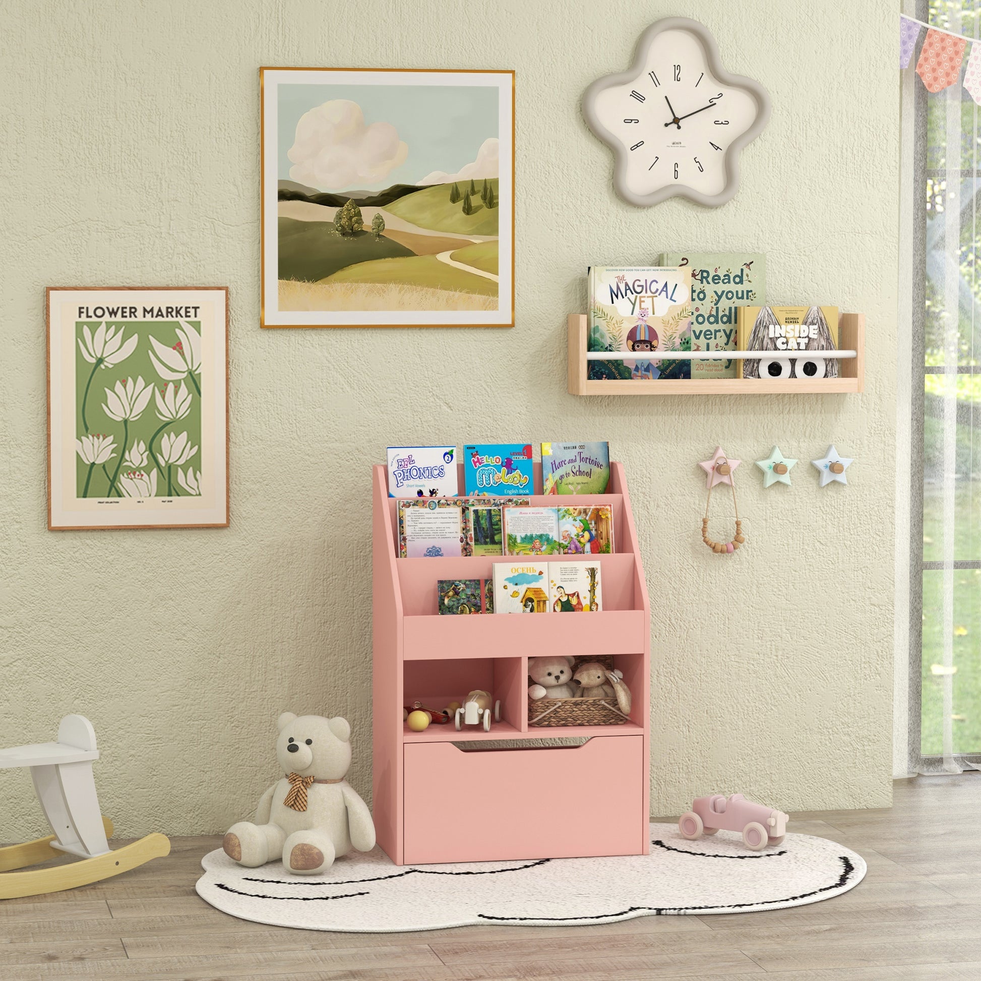 Pink toddler bookshelf with open shelves and a large drawer for toy storage