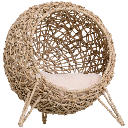 Round woven water hyacinth cat bed with a plush cream cushion