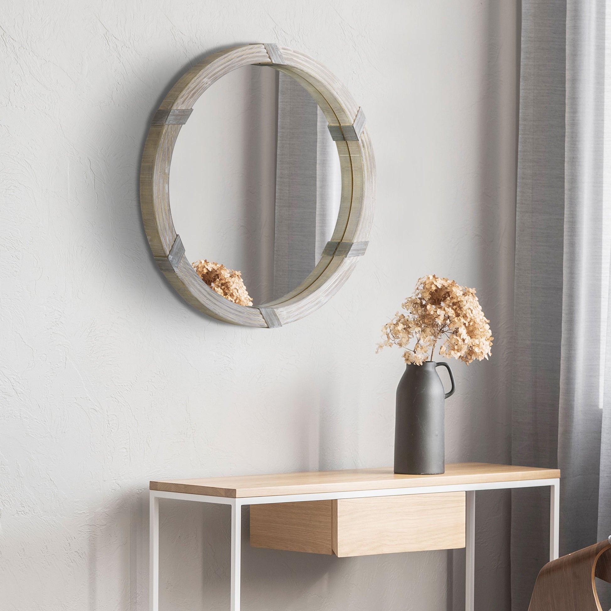 Round wall mirror with rustic grey wood frame and metal accents