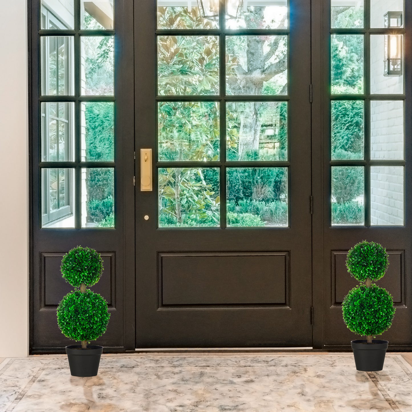 Twotiered artificial boxwood topiary in a black pot for entryway decor