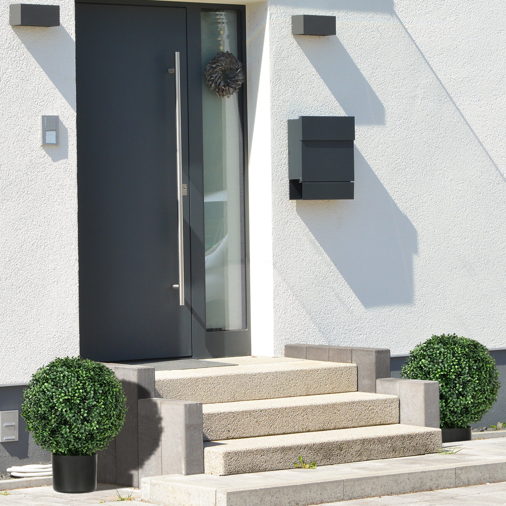 Modern dark grey front door with a brushed metal handle and a small window
