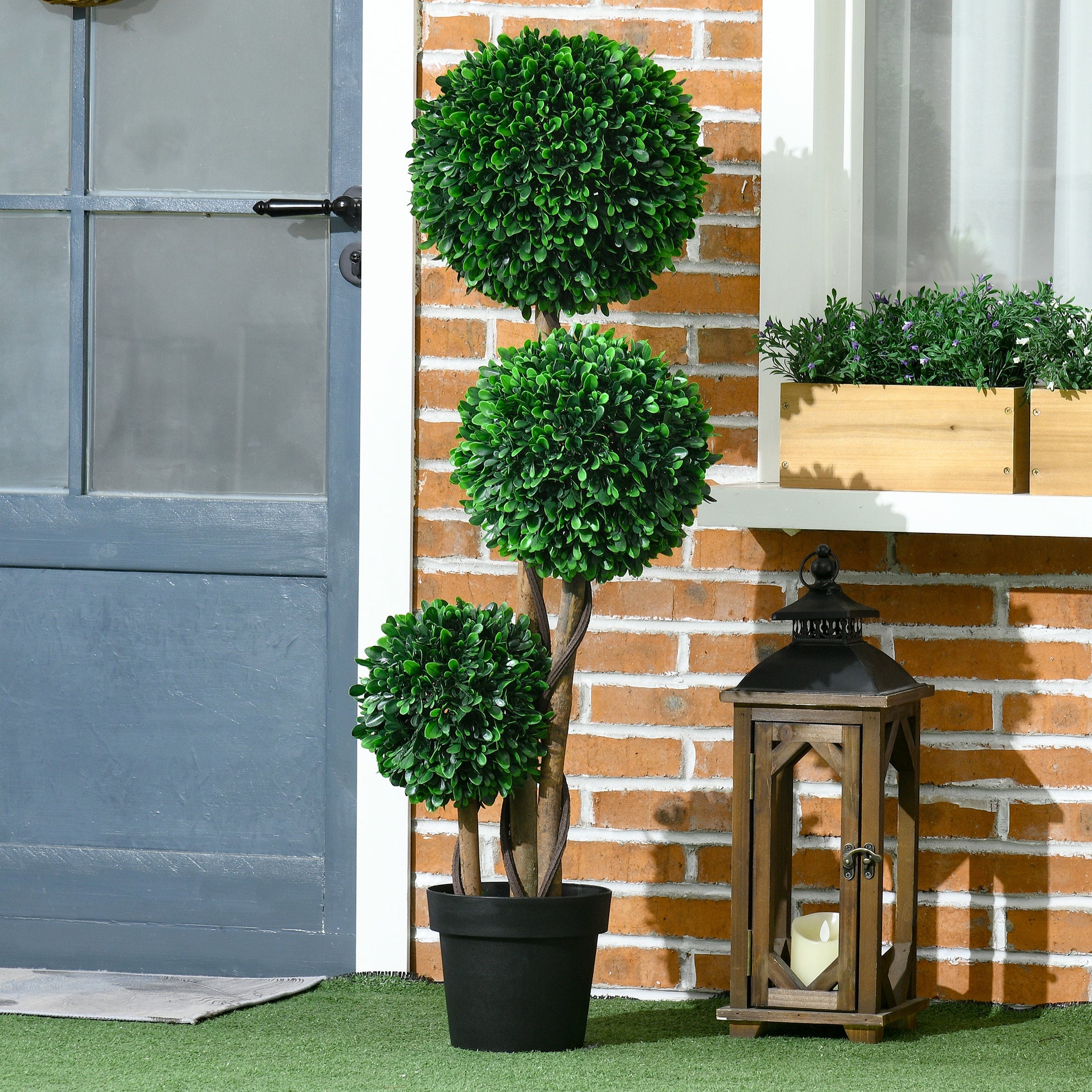 Tripleball faux boxwood topiary with textured brown trunk in a black planter