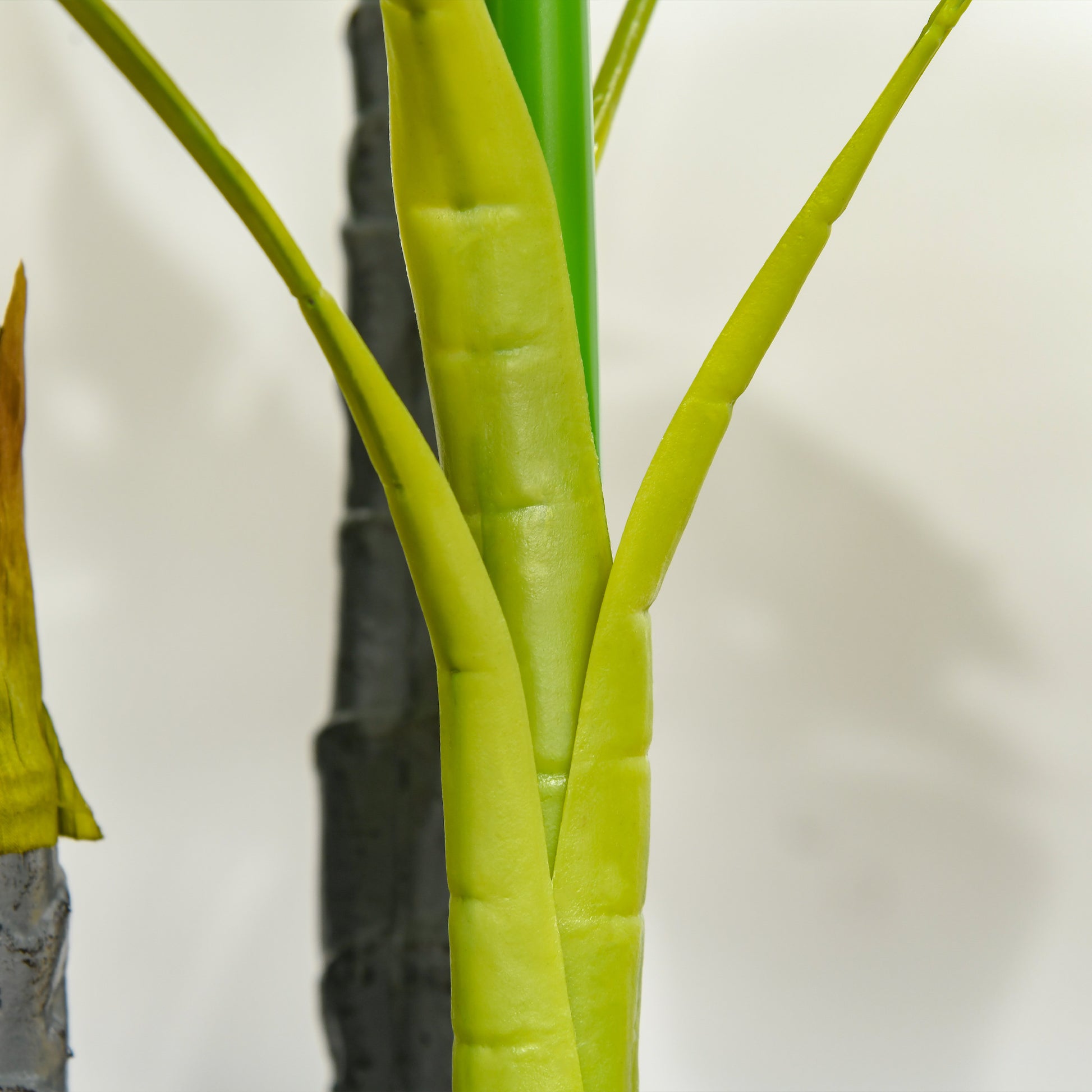 Closeup of a vibrant green faux plant stalk with ribbed texture for home decor