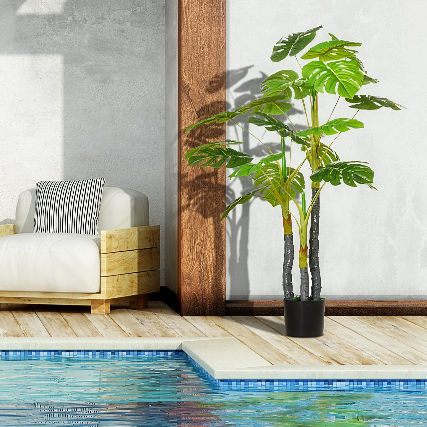 Tall artificial monstera plant with split green leaves in a black pot