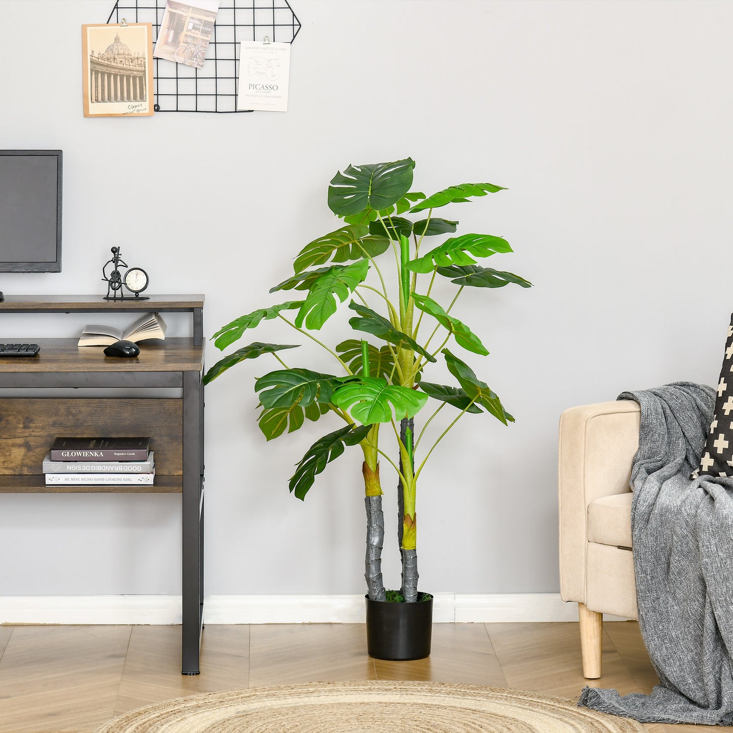 Tall artificial Monstera plant with split leaves in a black pot ideal for home decor
