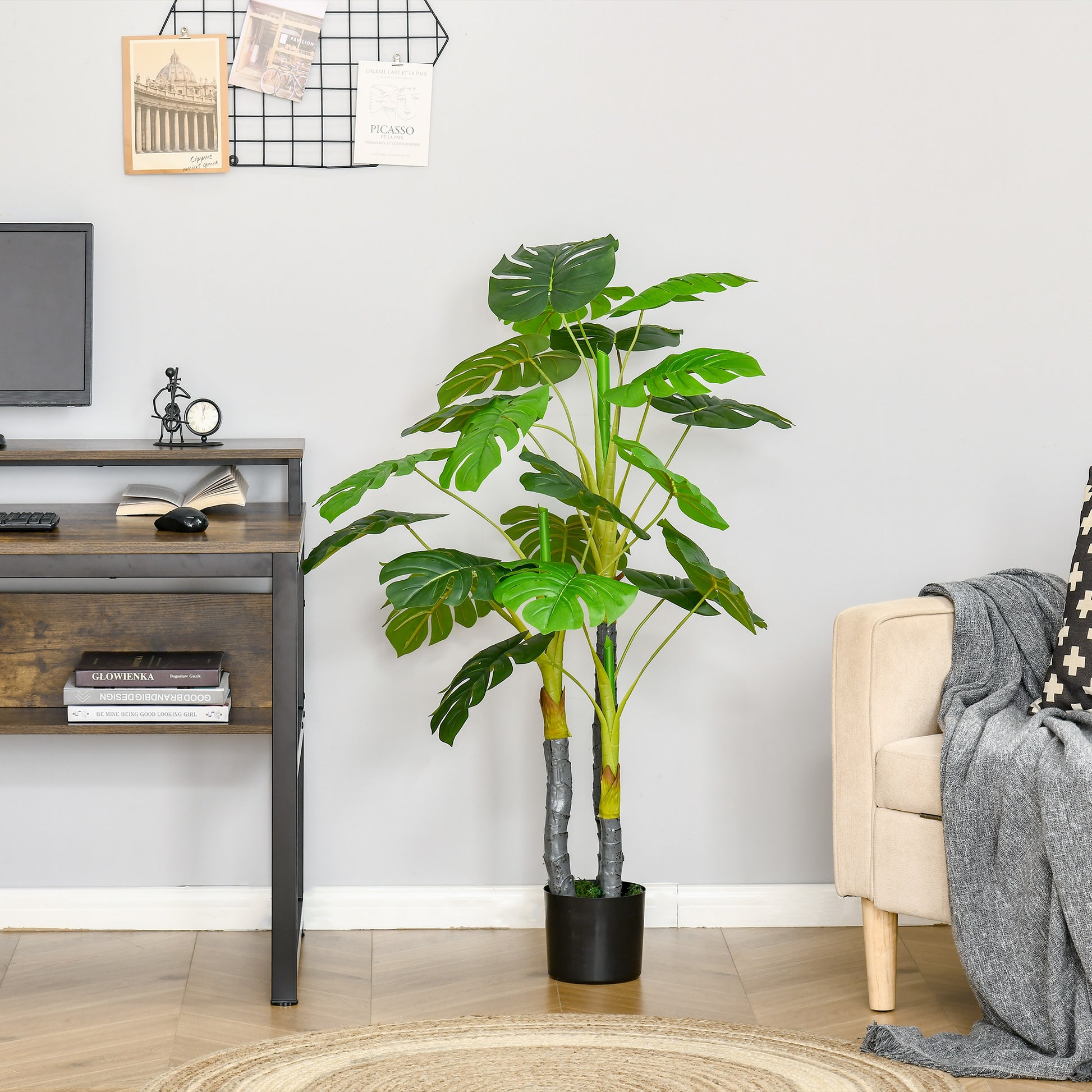 Tall artificial Monstera plant with split leaves in a black pot ideal for home decor