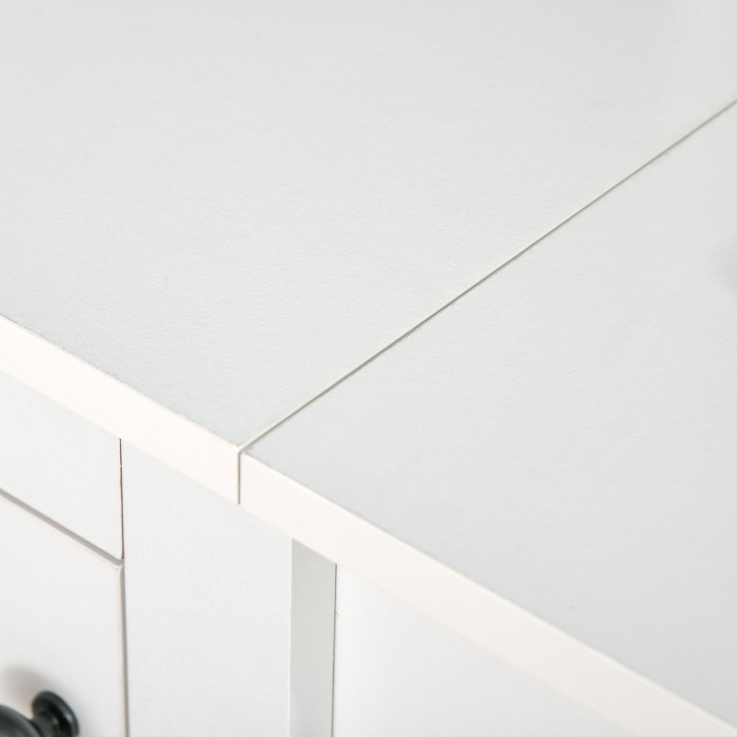 White wooden nightstand with two drawers and dark knobs