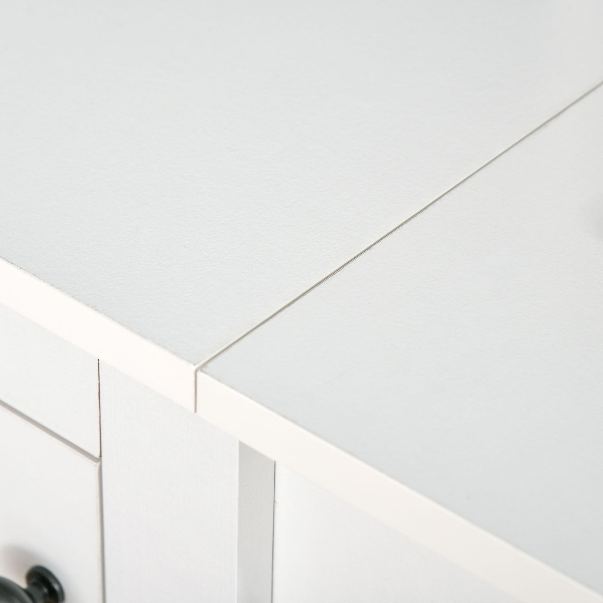 White wooden nightstand with two drawers and dark knobs