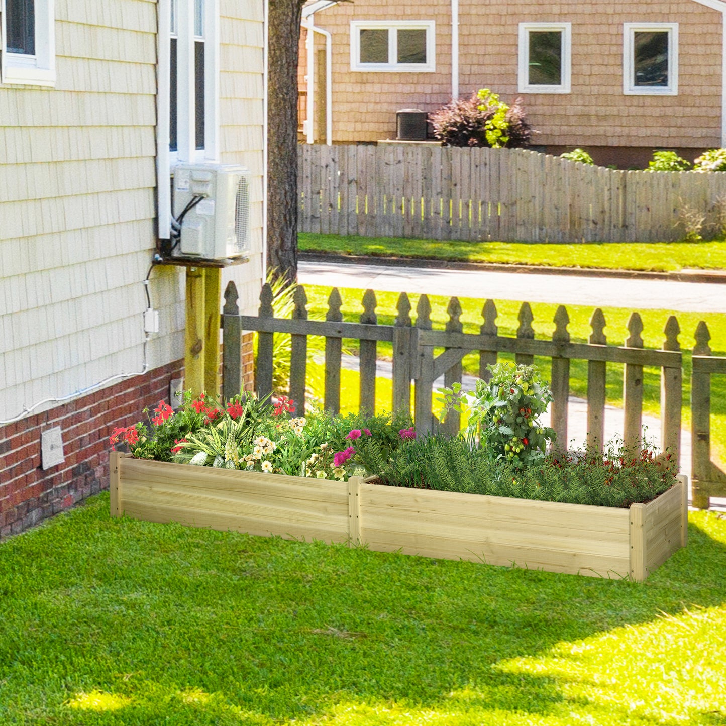 Two wooden raised garden beds with blooming flowers and herbs in a backyard