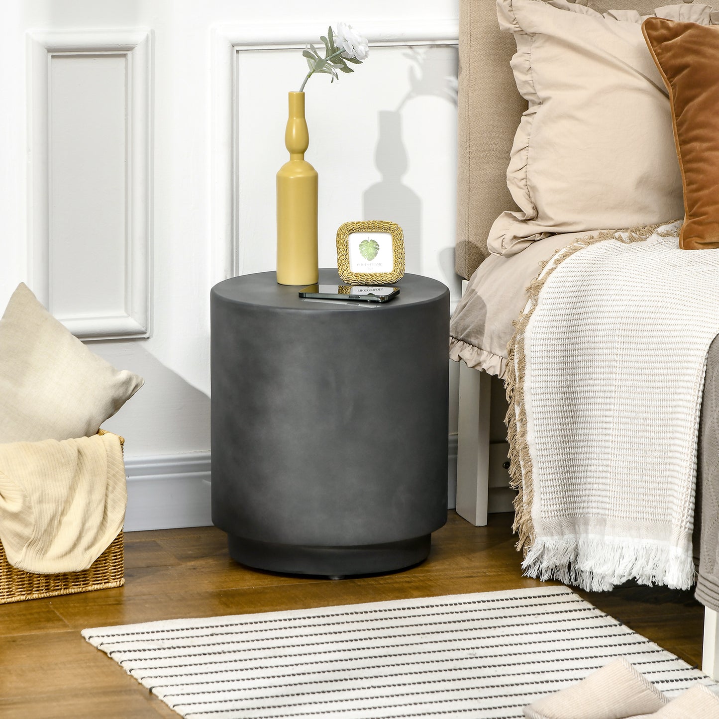 Dark gray cylindrical bedside table with modern minimalist design