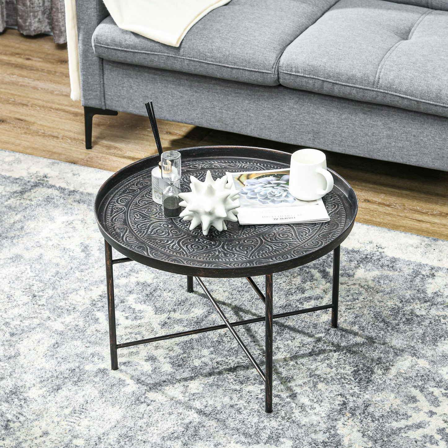 Ornate antique bronze round metal tray table with decorative embossed pattern