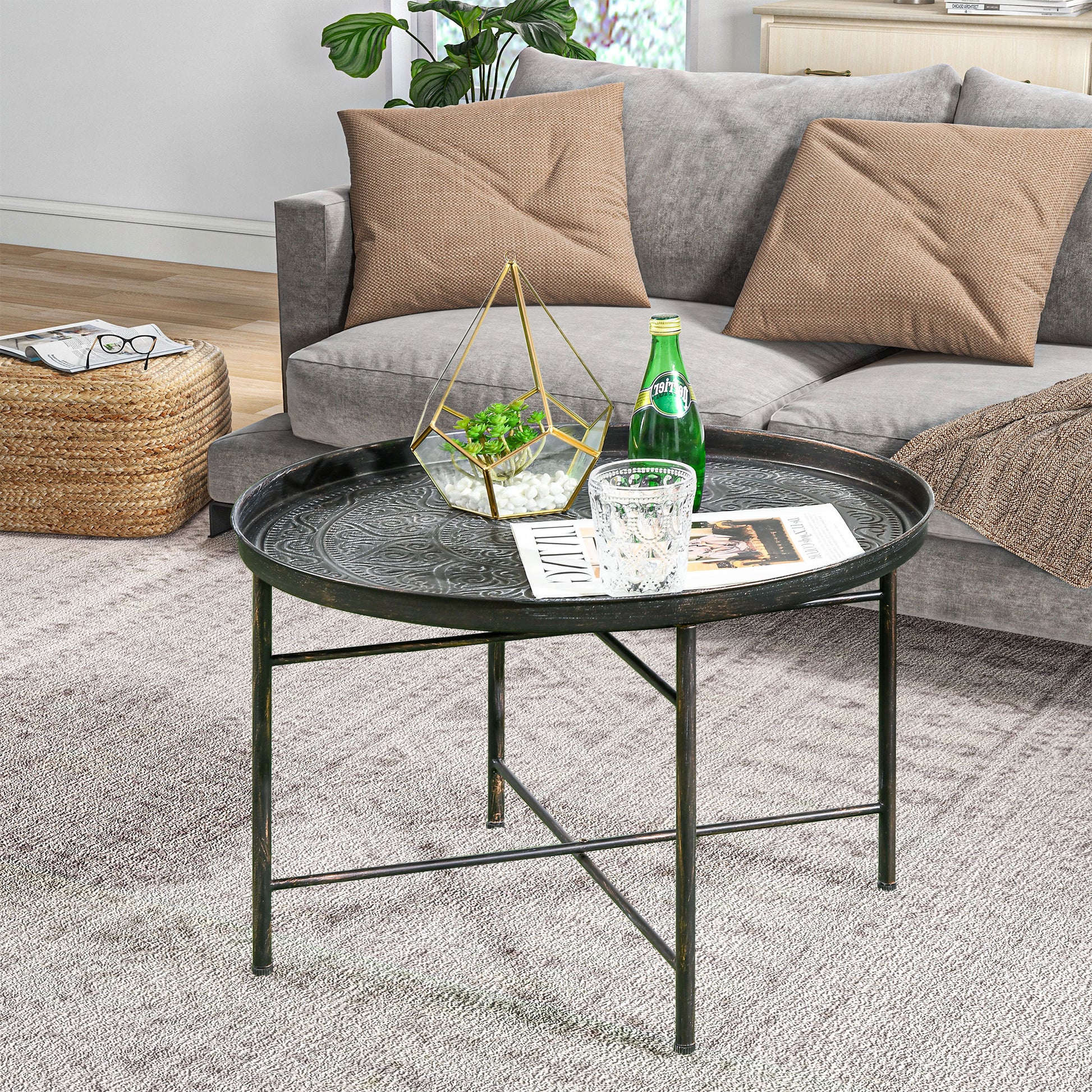 Round antique black metal coffee table with embossed pattern for living room accent