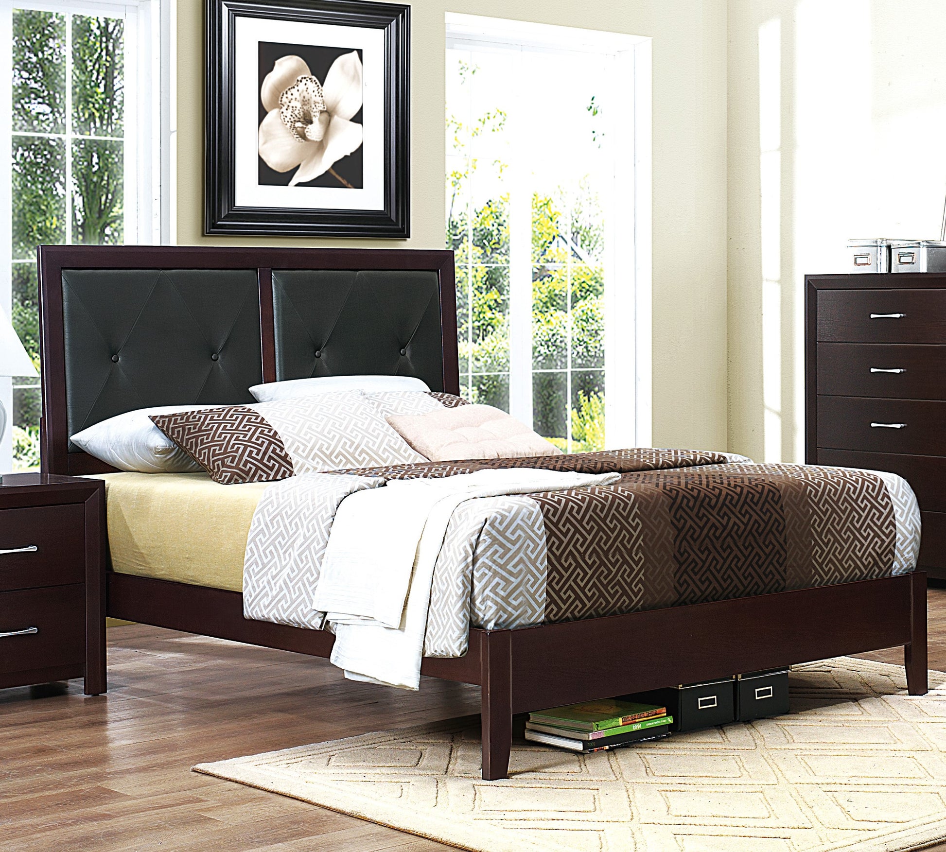 Dark brown wooden bed frame with tufted black headboard and geometric bedding