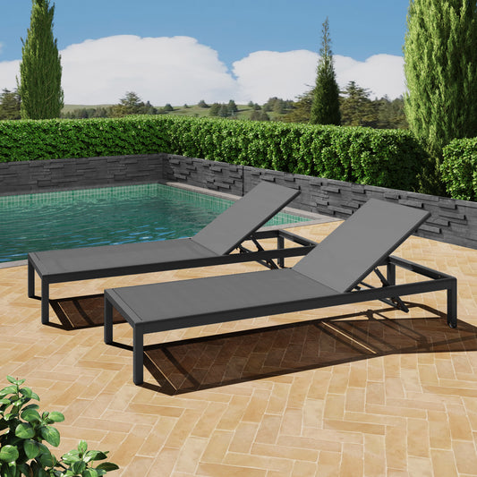 Two dark grey aluminum chaise lounge chairs with grey mesh fabric for poolside relaxation