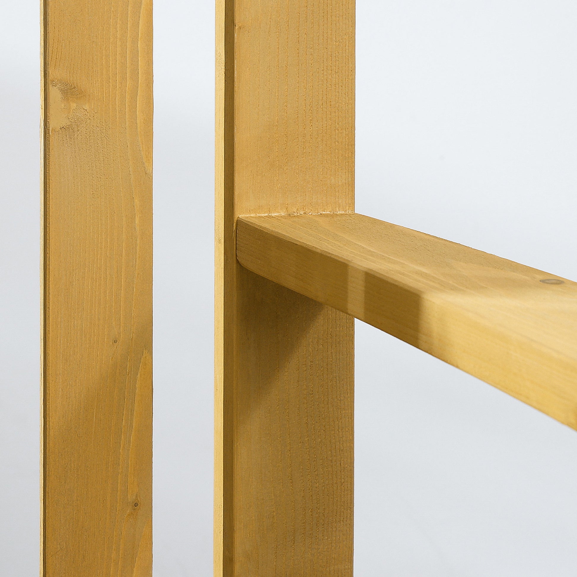 Closeup of light brown pine wood planks with visible grain and knots ready for outdoor furniture construction