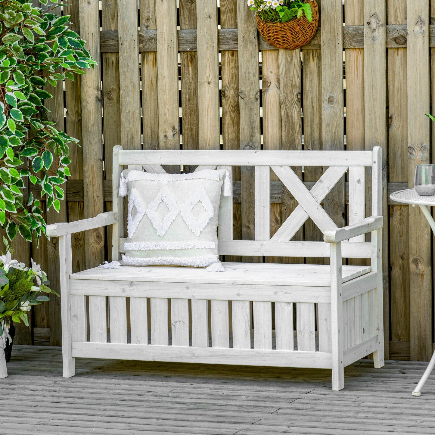 White wooden garden bench with storage featuring Xdesign back and decorative pillow