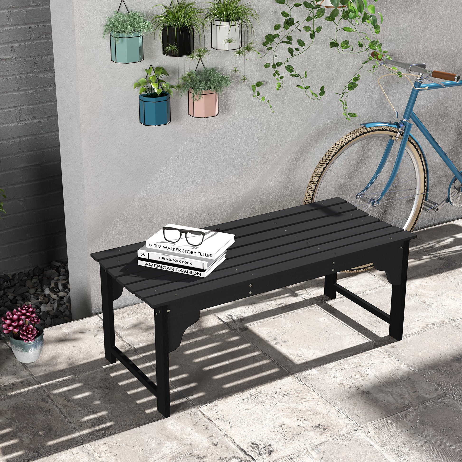 Black slatted outdoor bench with decorative legs perfect for garden patios