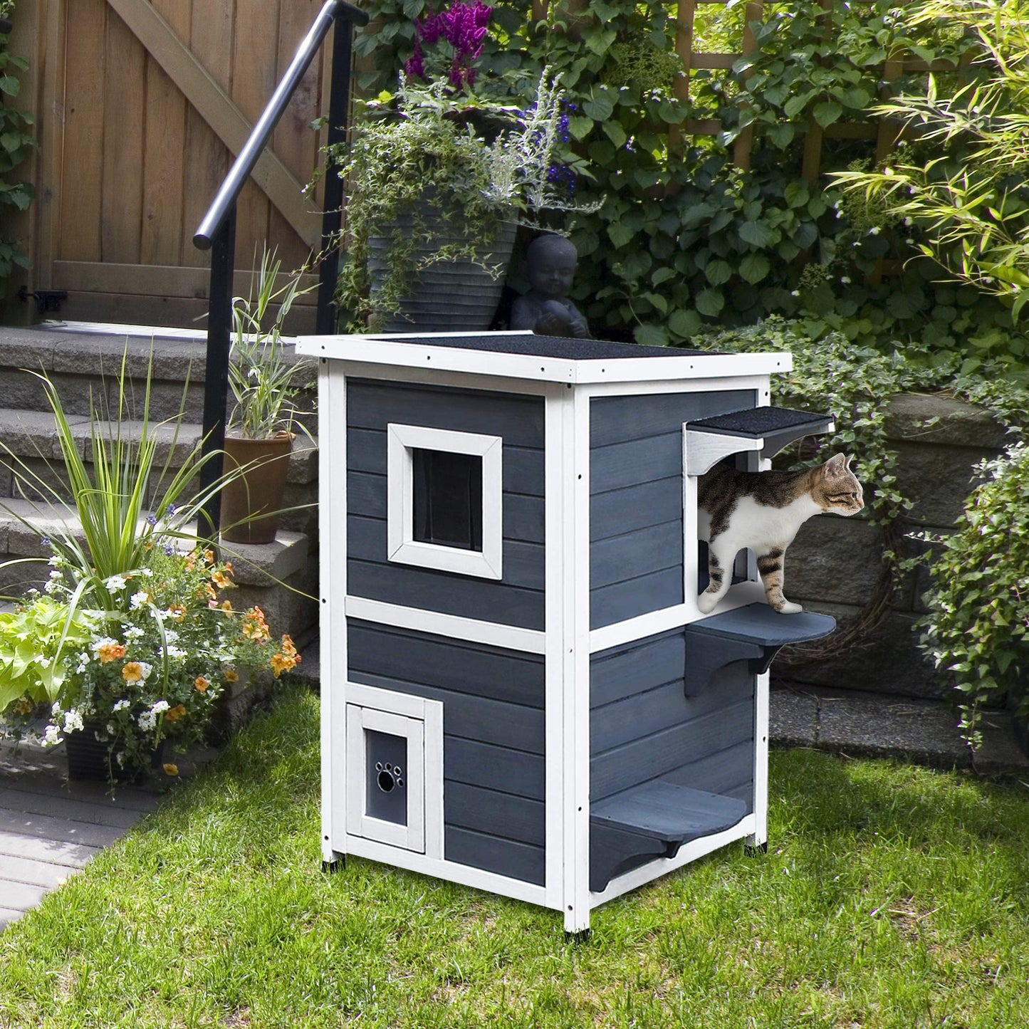 Twostory grey outdoor cat house with white trim and a playful cat emerging from an upper window