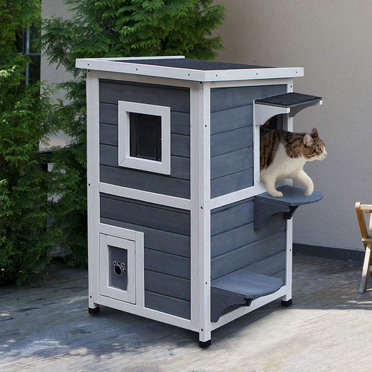 Grey and white wooden outdoor cat house with multiple levels and a paw print window detail