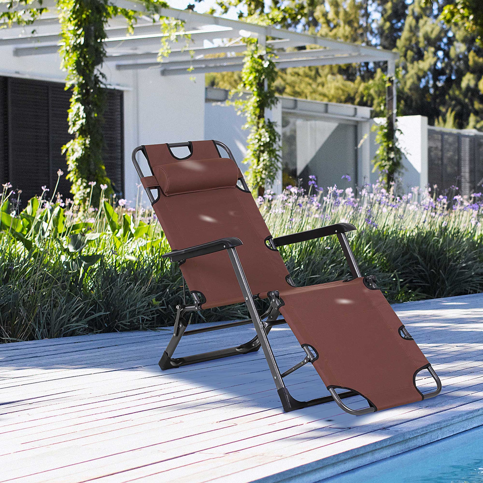 Brown zero gravity chair with metal frame and headrest on a wooden deck