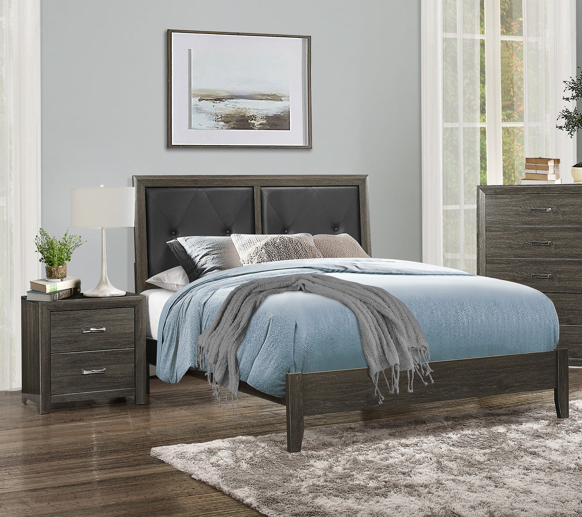 Gray tufted headboard modern bed frame with blue bedding and a nightstand
