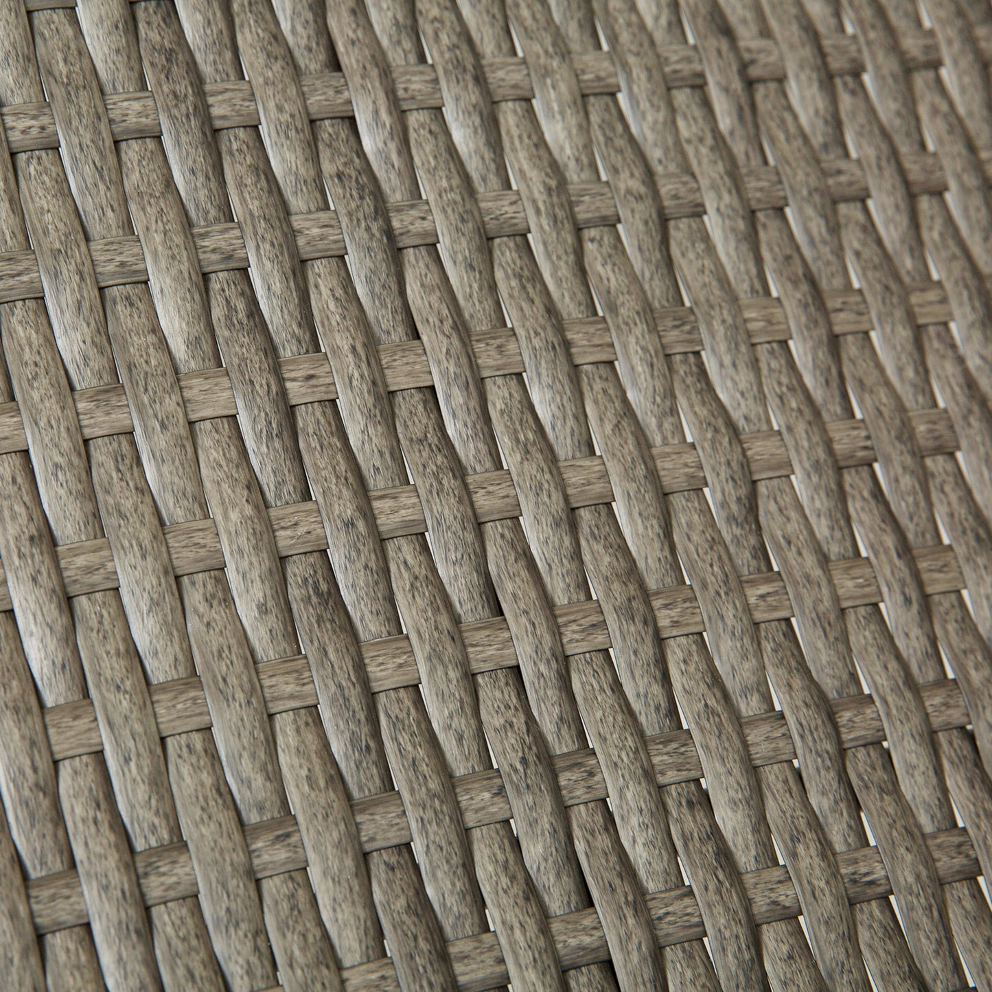 Closeup of grey wicker weave texture on an outdoor chair cushion
