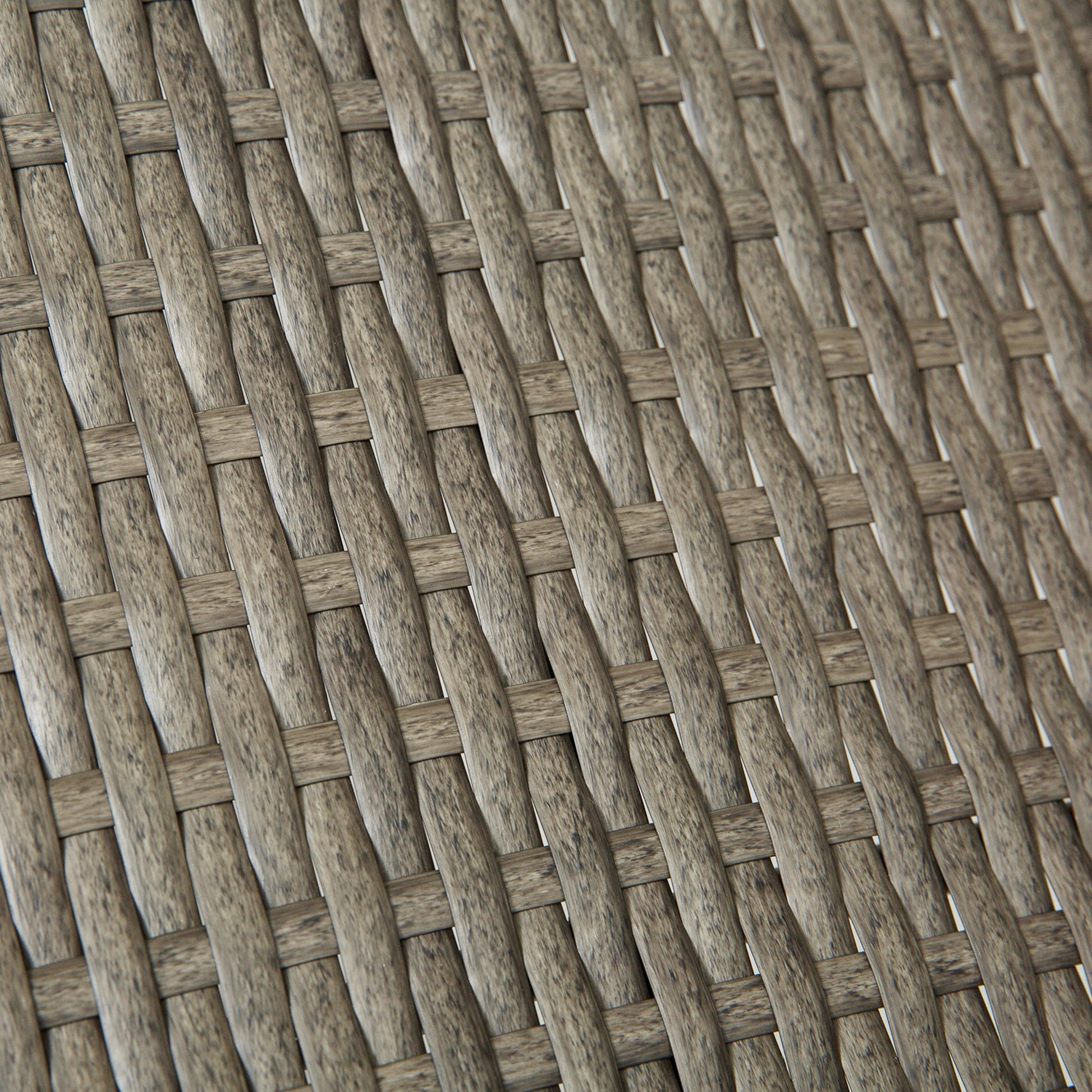 Closeup of grey wicker weave texture on an outdoor chair cushion