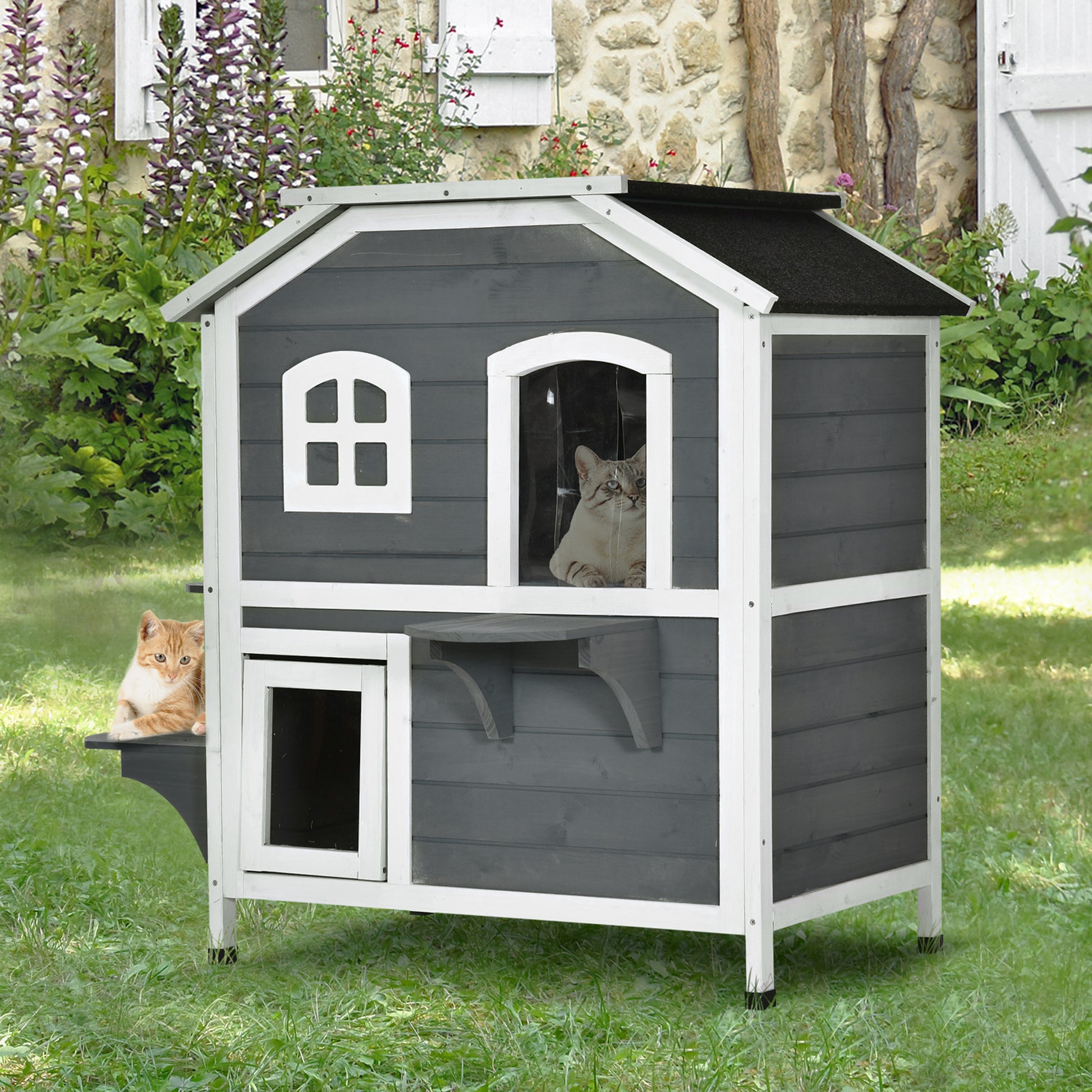 Twotier gray wooden cat house with windows and perches ideal for outdoor pets