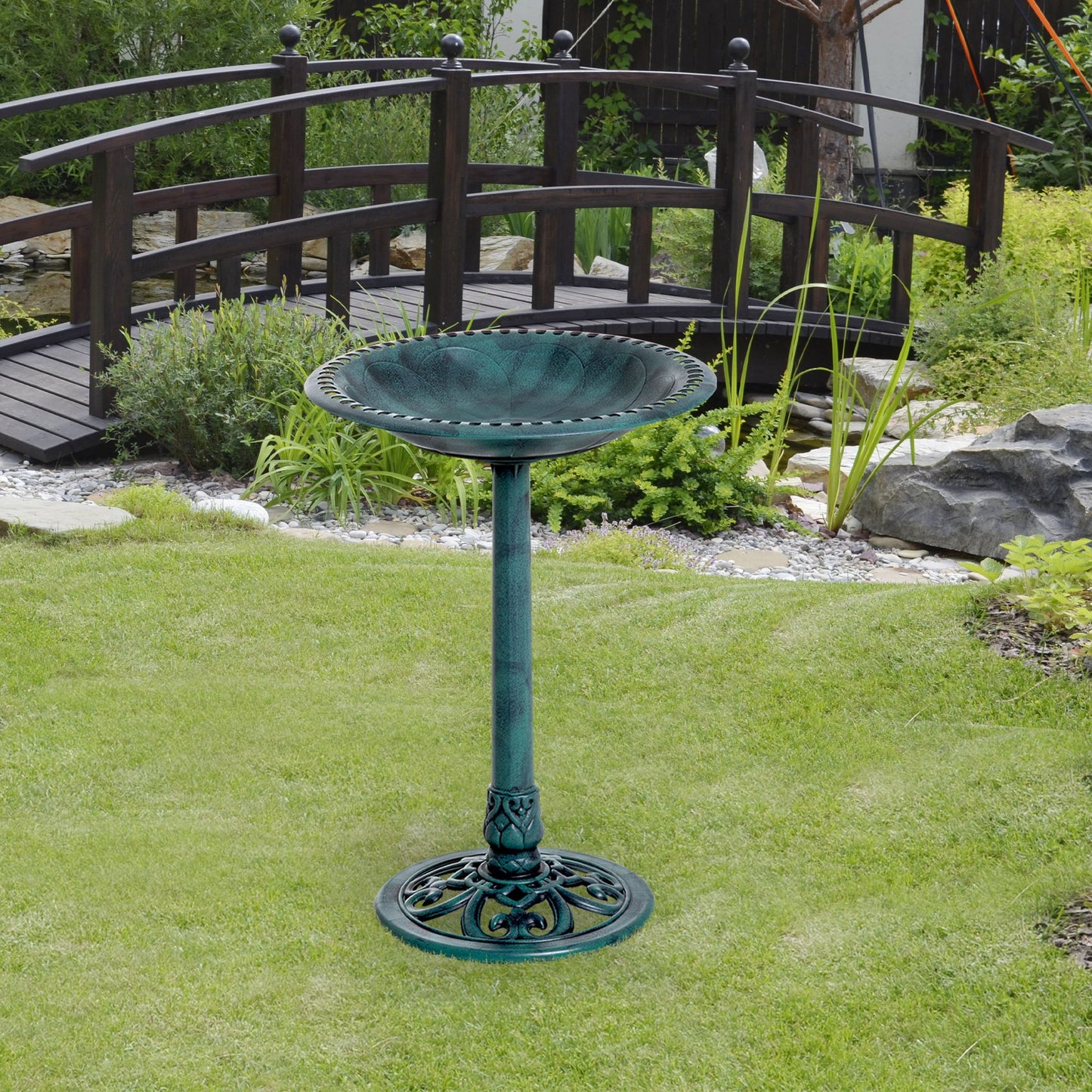 Ornate green metal bird bath with pedestal and decorative base for garden