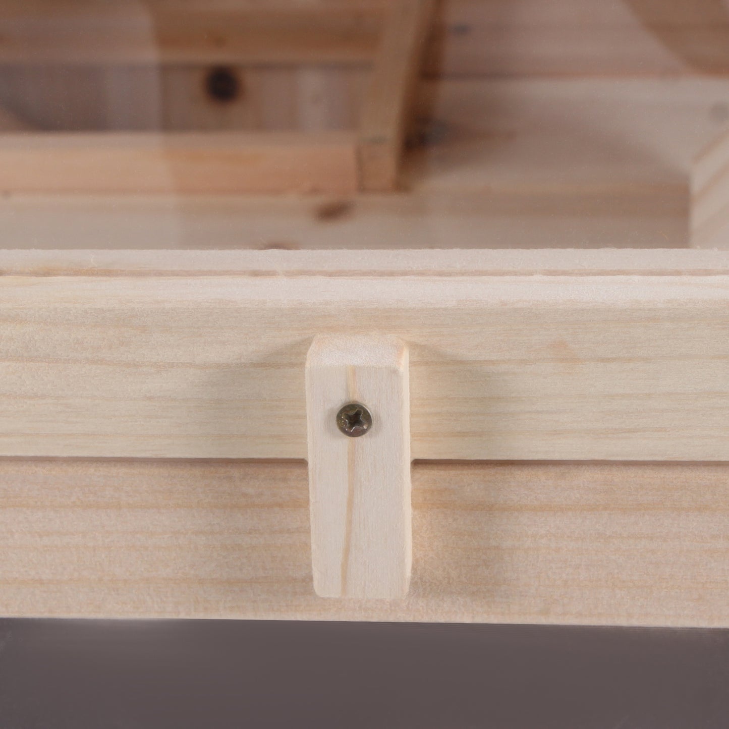 Natural pine wood plank with visible grain and a single screw fastener