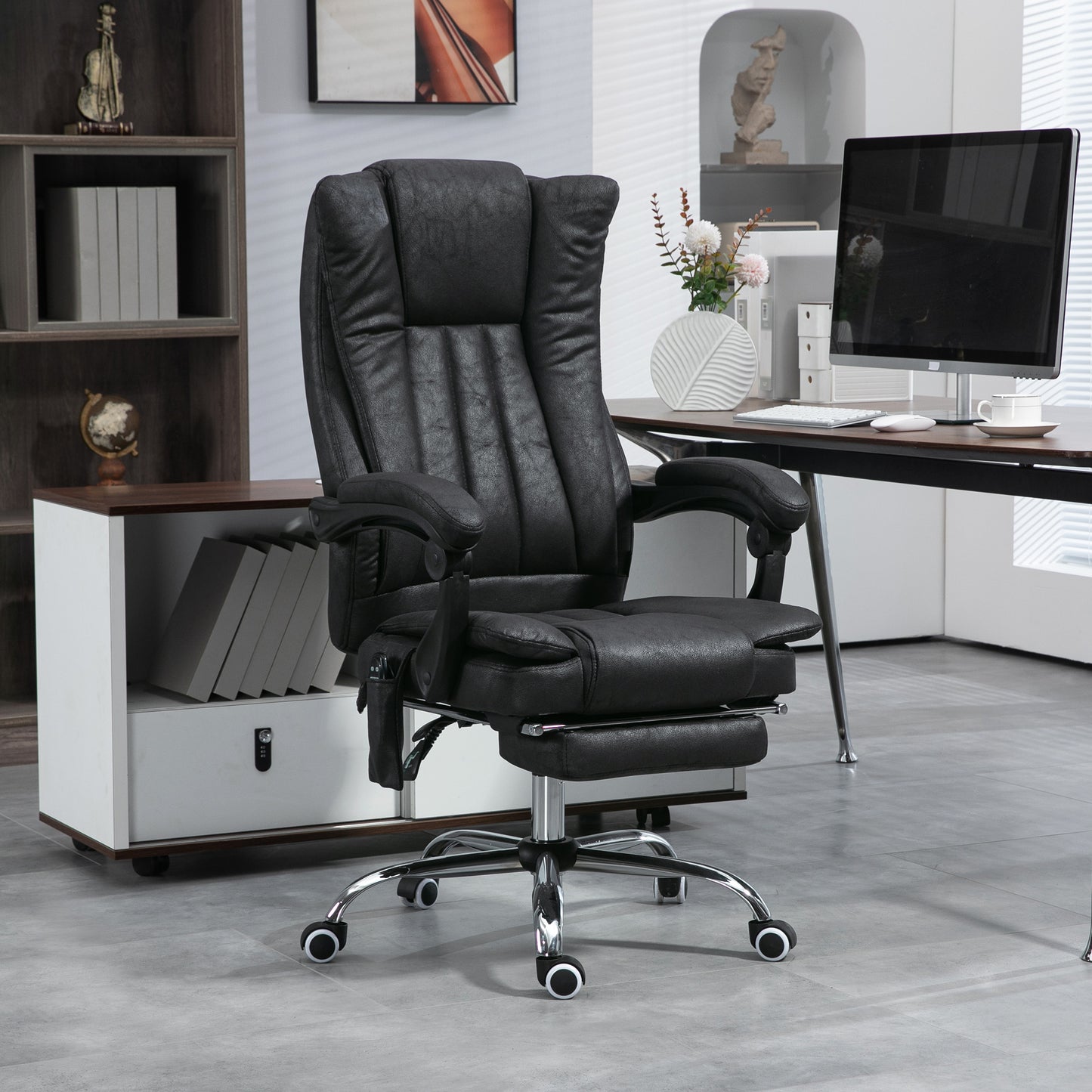 Black executive office chair with builtin footrest and massage function