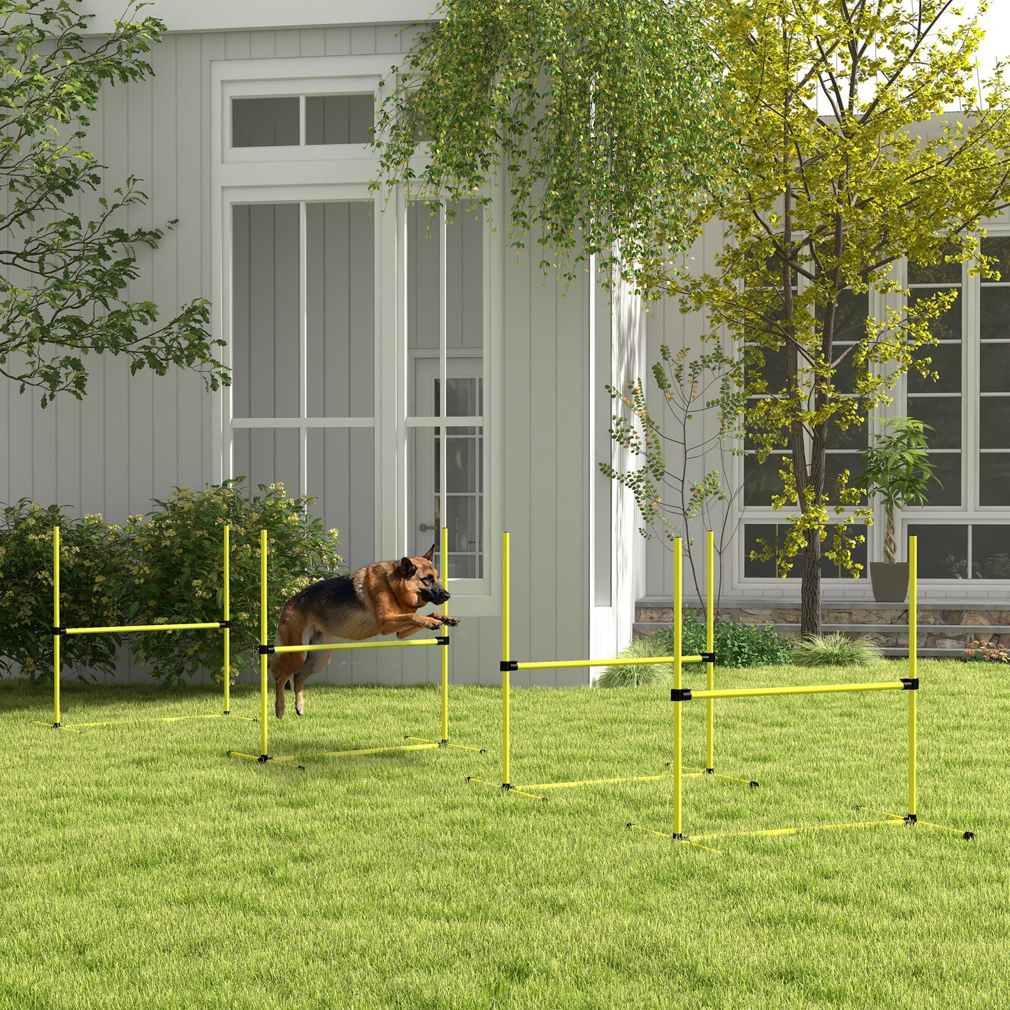 German Shepherd dog jumping over yellow agility hurdle in backyard