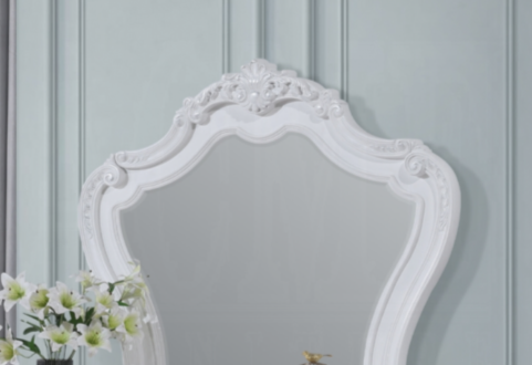 Ornate white rococo mirror with scrolling carved details