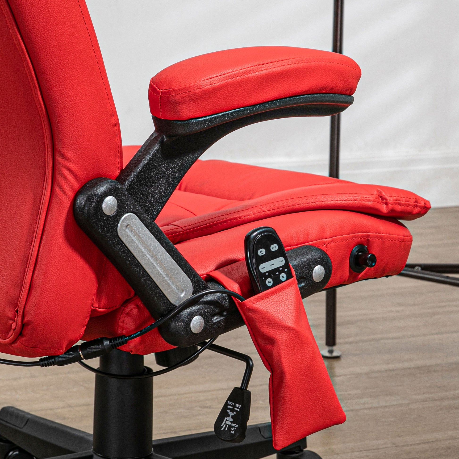 Red faux leather ergonomic chair with adjustable armrests and a side pocket holding a remote control