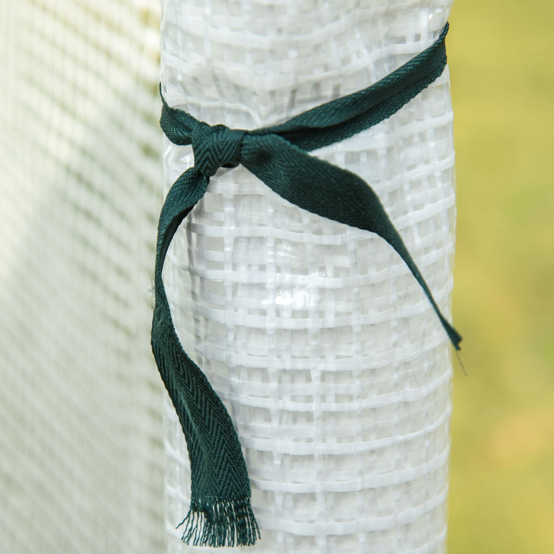 Rolled white geotextile fabric with a dark green ribbon tie ideal for erosion control