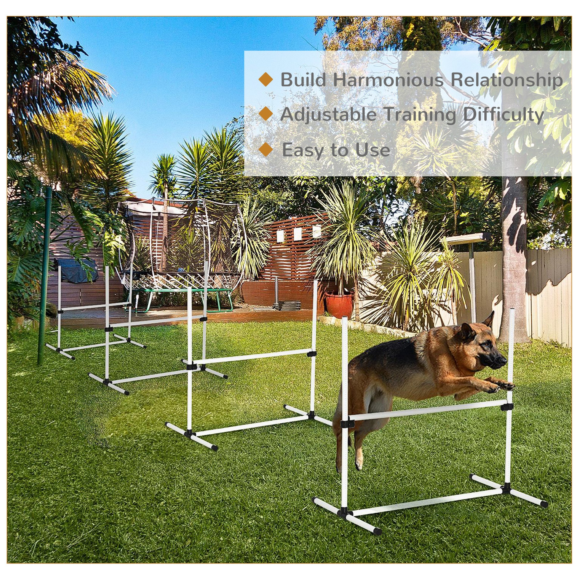 German Shepherd dog jumping over a white agility hurdle in a grassy backyard dog training equipment