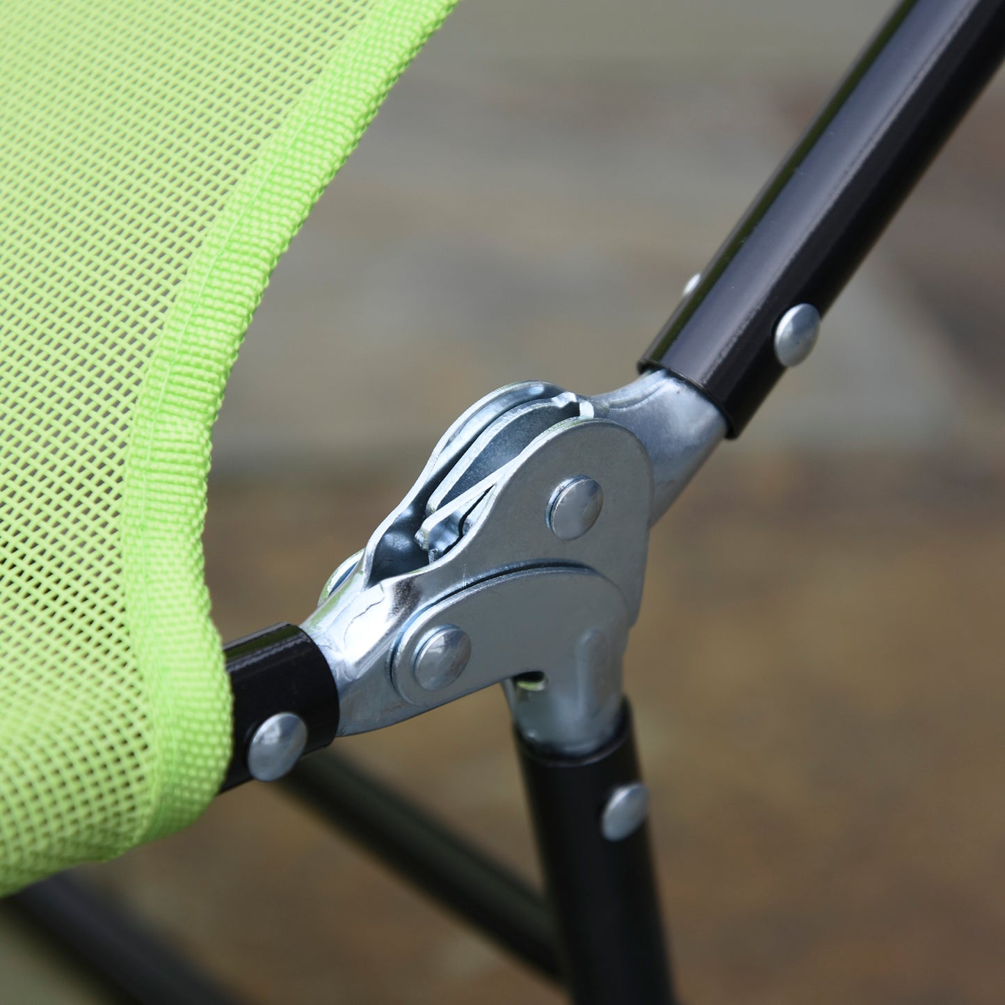 Closeup of a green mesh fabric with reinforced stitching on a folding chair